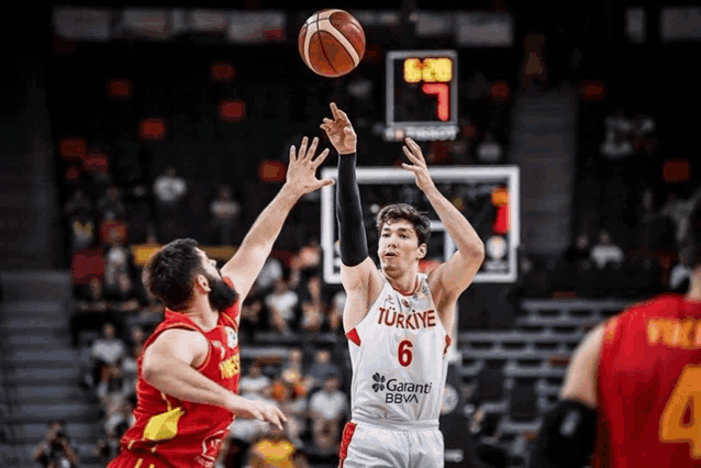 a basketball player wearing a turkey jersey shoots a ball