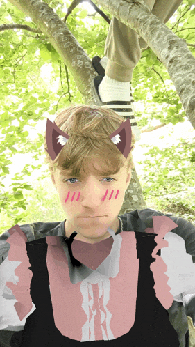 a boy with cat ears on his head and a pink shirt