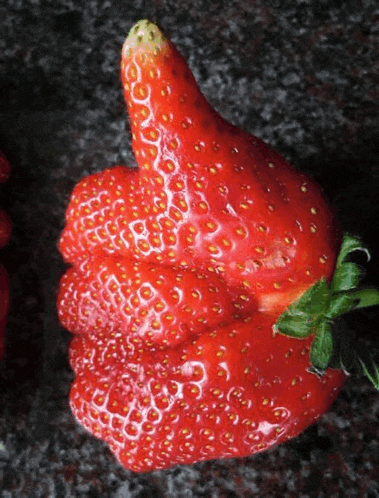 a strawberry shaped like a thumbs up sign