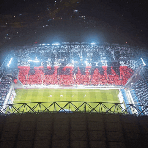 a soccer stadium with a crowd of people and a sign that says ' fc barcelona ' on it