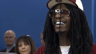 a man with dreadlocks wearing sunglasses and a hat