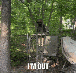 a man in a military uniform stands behind a chain link fence with the words i 'm out below him