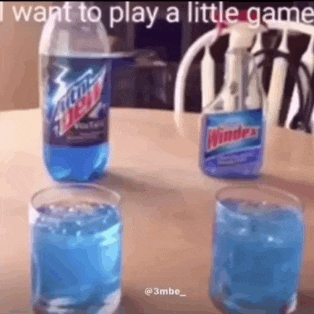 a bottle of mountain dew and a bottle of windex are on a table next to two glasses of blue liquid .