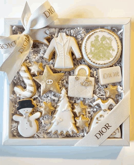 a box of dior cookies with a white ribbon around it