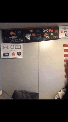 a wall with a bunch of under armour posters on it