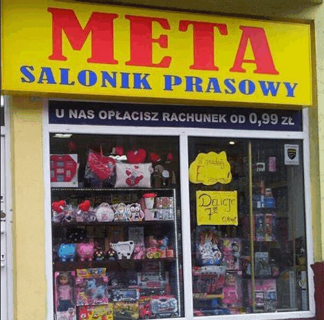 a store front with a yellow sign that says meta salonik prasowy on it