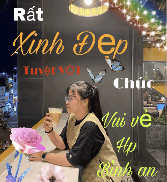 a woman sits at a table with a cup of coffee in front of a sign that says rat xinh dep