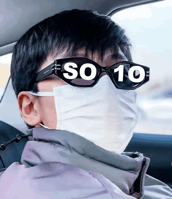 a man wearing a mask and sunglasses with the number 10 on them