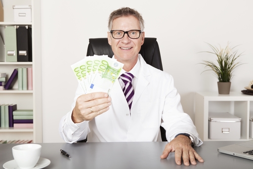 Happy pharmacist holding money