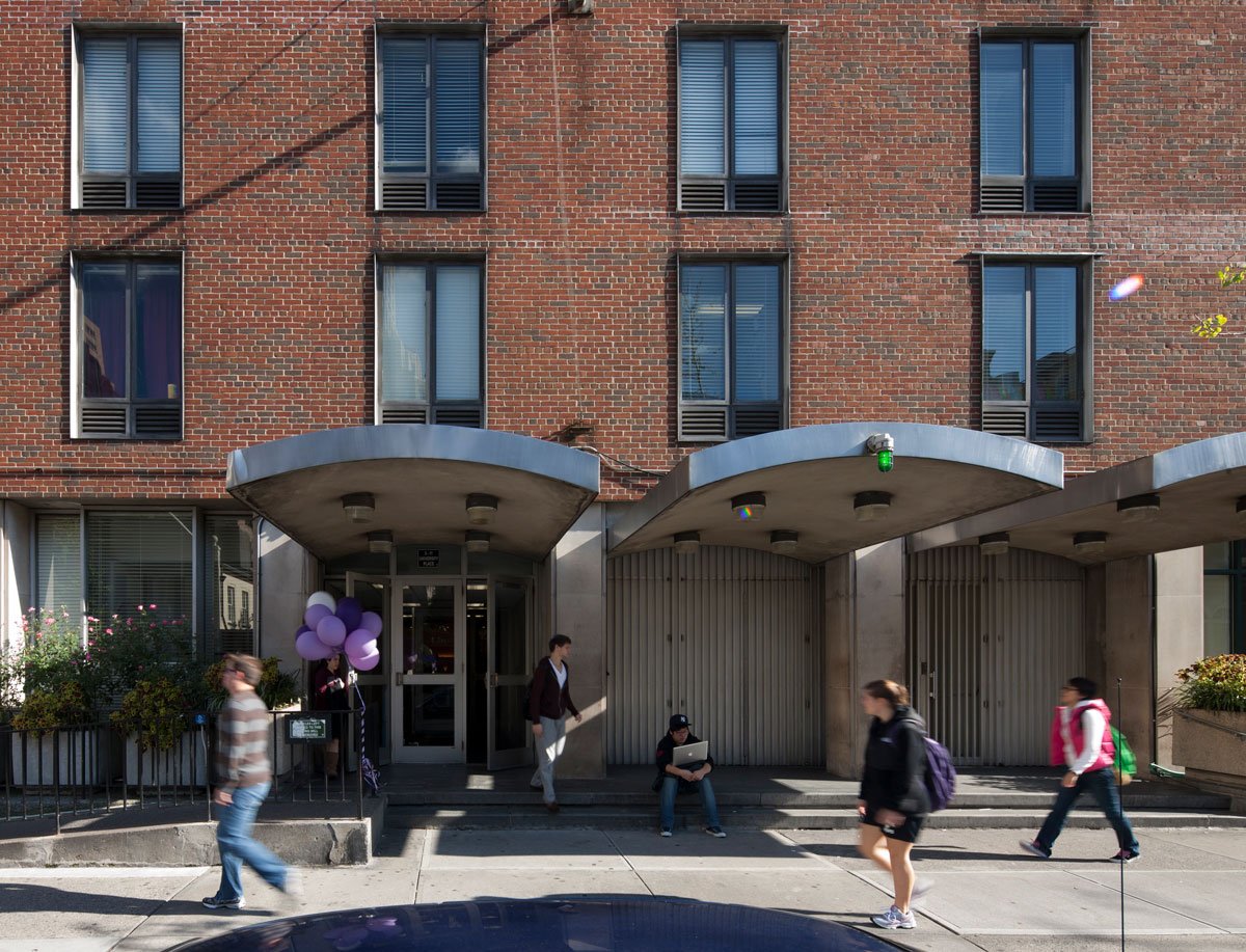 Students walk past an NYU residence hall.