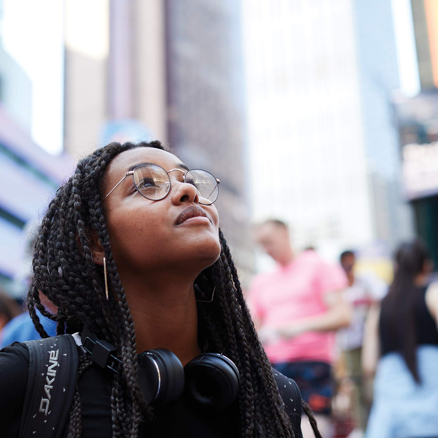 Student looking up in Times Square.