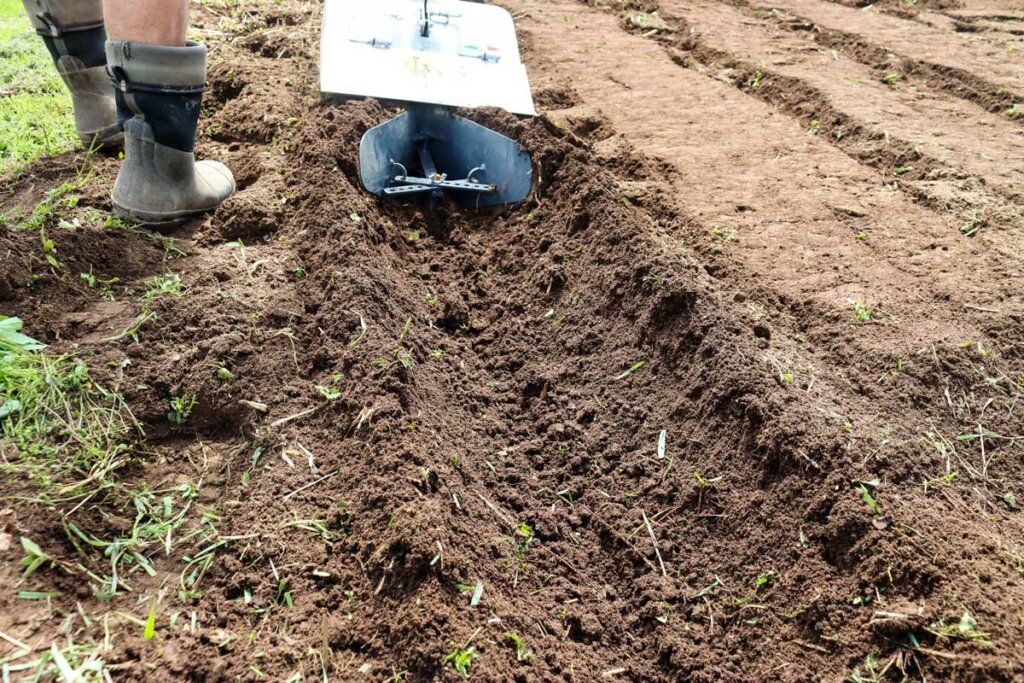 Close up shot of the BCS tractor digging a ditch.