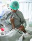 Patient Ana Gabriela is comforted by her father while waiting to receive her diagnostic heart catheterization.