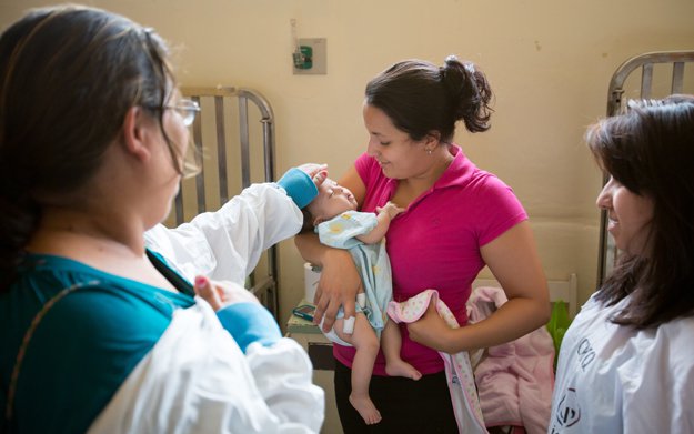 Fanny Ortez Sanchez receives a cuddle from her mother before being taken to surgery.