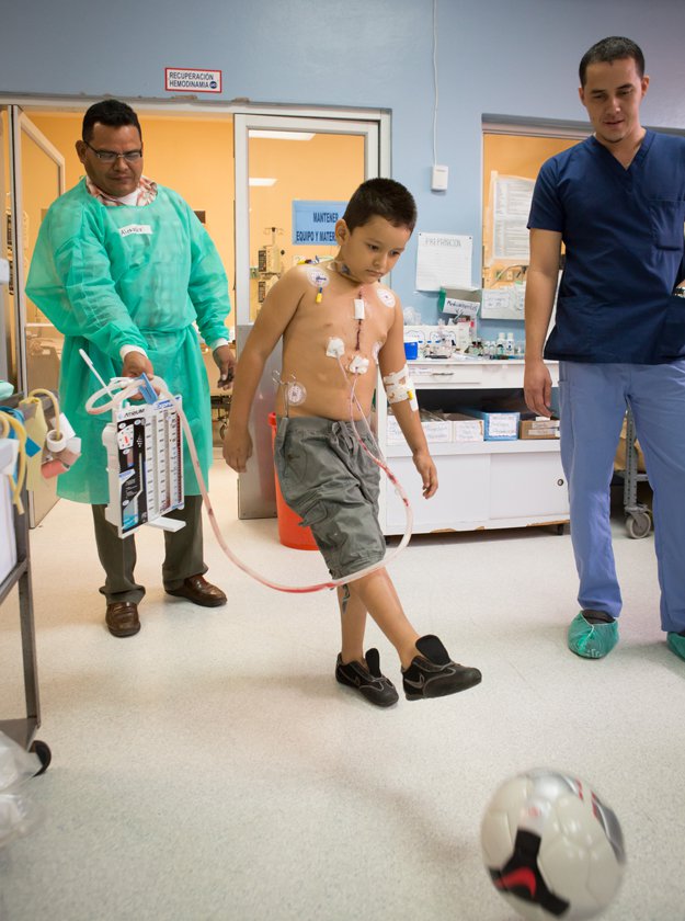 Only one day after surgery, patient Isander David  finds strength to kick a soccer ball.