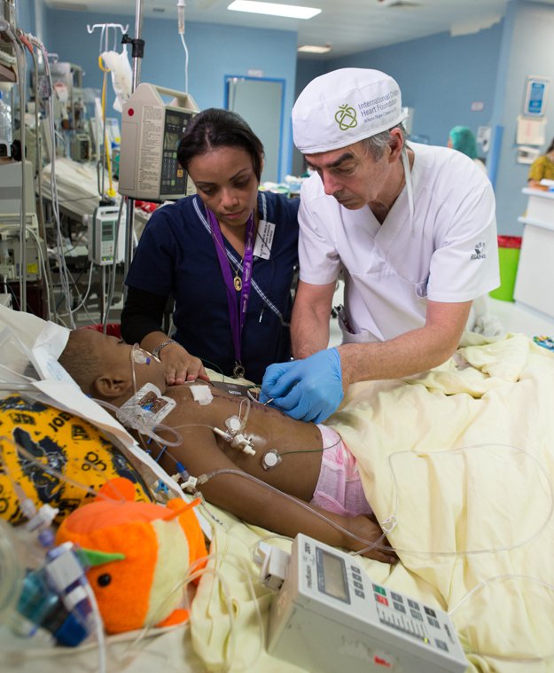 Dr. Glenda Lopez and Dr. Tom Higgins tend to Juan Manuel in pediatric ICU.