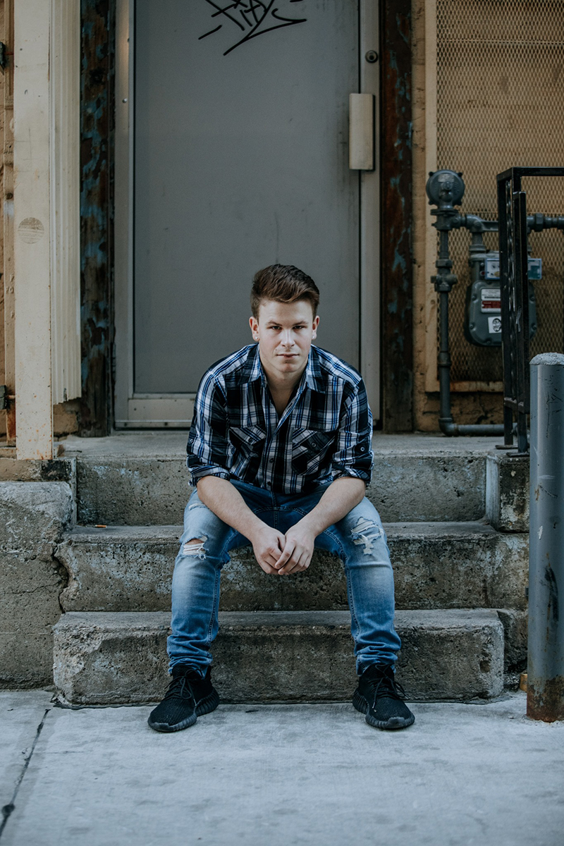 Sitting on stairs is one of the best photo poses for men