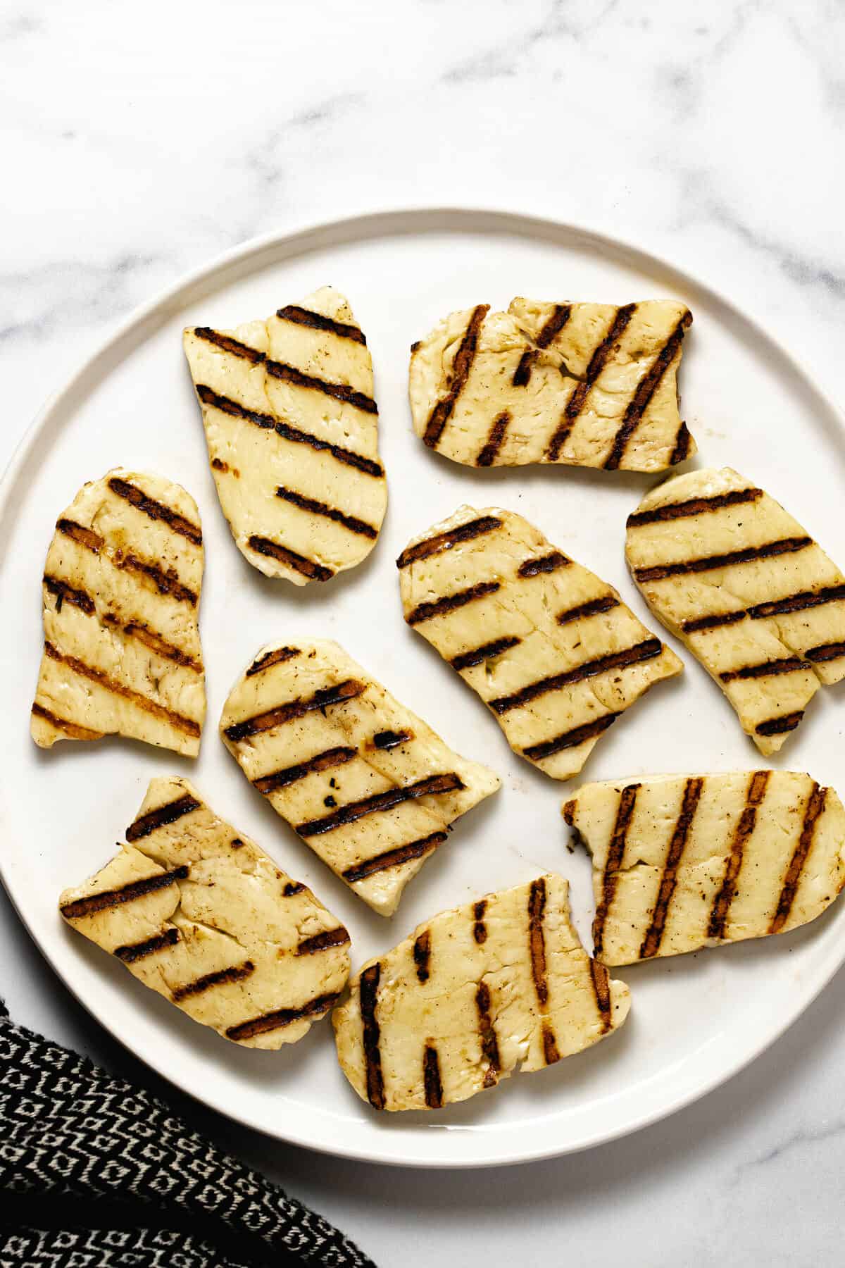 White plate filled with grilled halloumi cheese