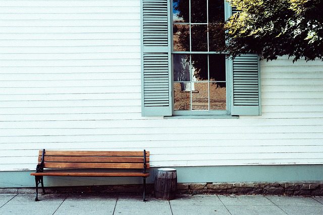 a bench sits in front of a building ready for cold climates