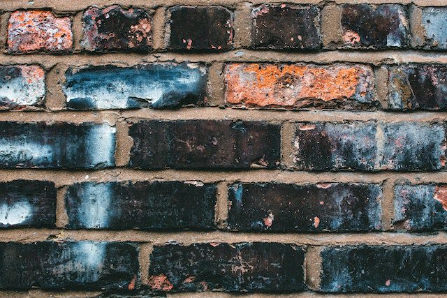 a wall with stained bricks because of cold climates