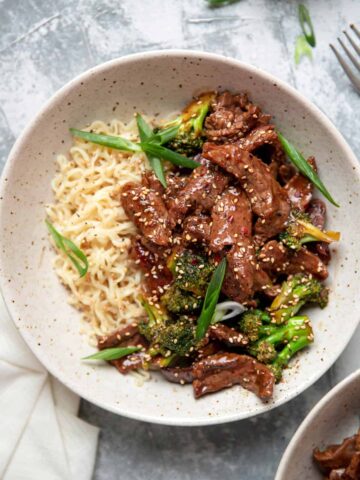 beef and broccoli with ramen noodles in a bowl.