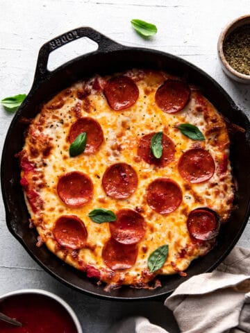 cheese and pepperoni pizza cooked in a cast iron skillet.