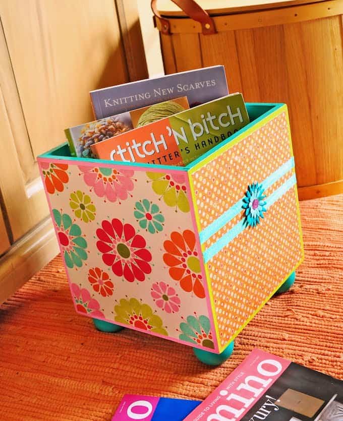 Storage doesn't have to be boring! I used bright paints, paper and decoupage on this wood storage bin - and now I'm storing my books in style.