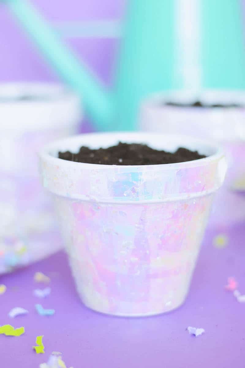 These terracotta plant pots are unicorn inspired, with iridescent cello wrap applied with Mod Podge and confetti. Perfect for parties!