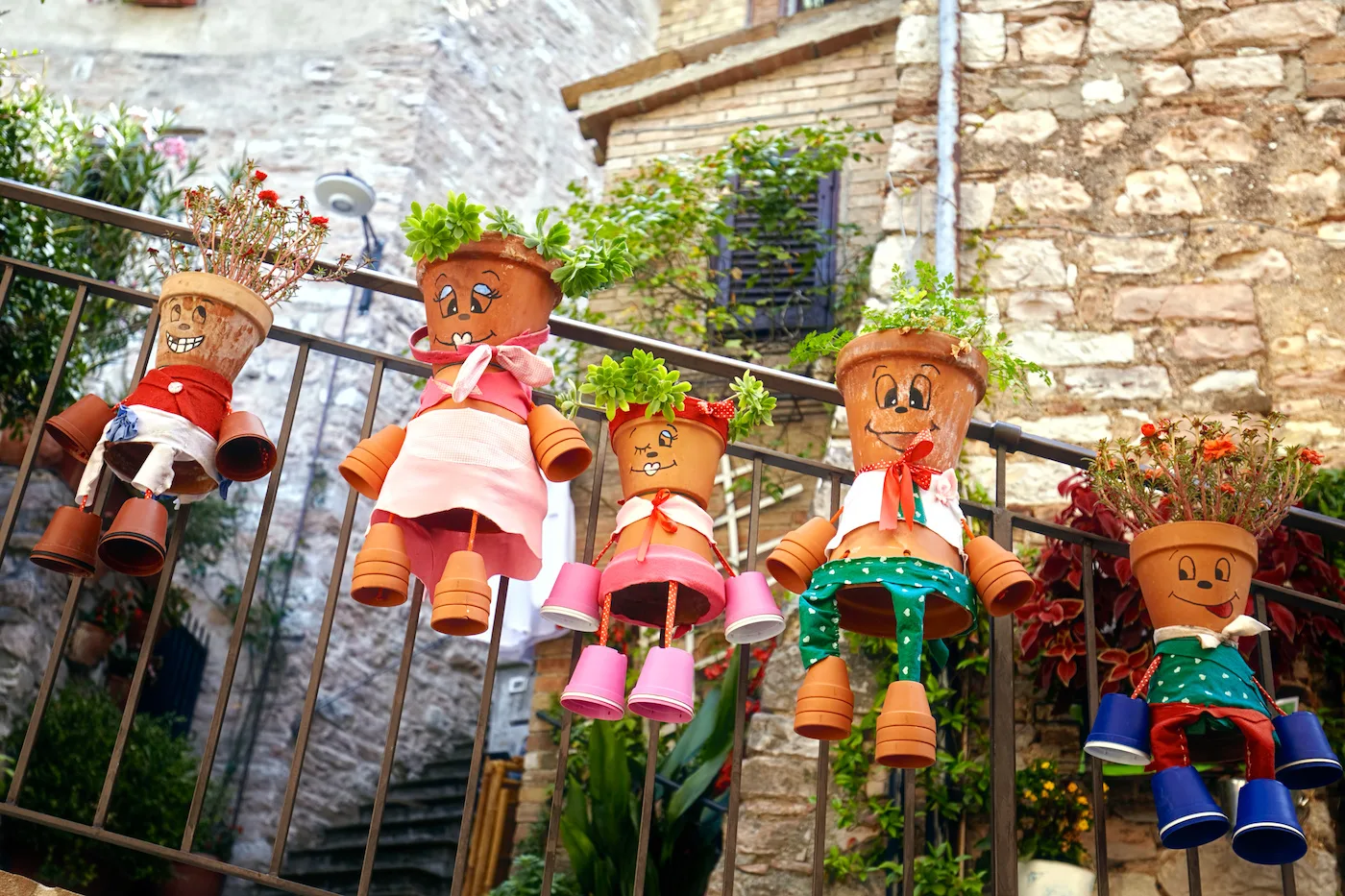 Painted-clay-pot-people-out-in-a-garden