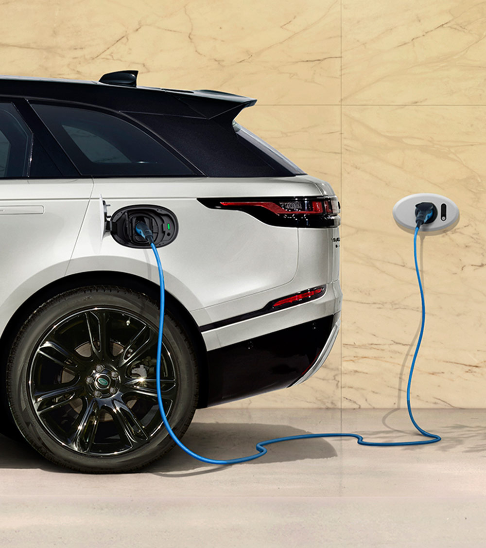 A white electric car that is charging. 