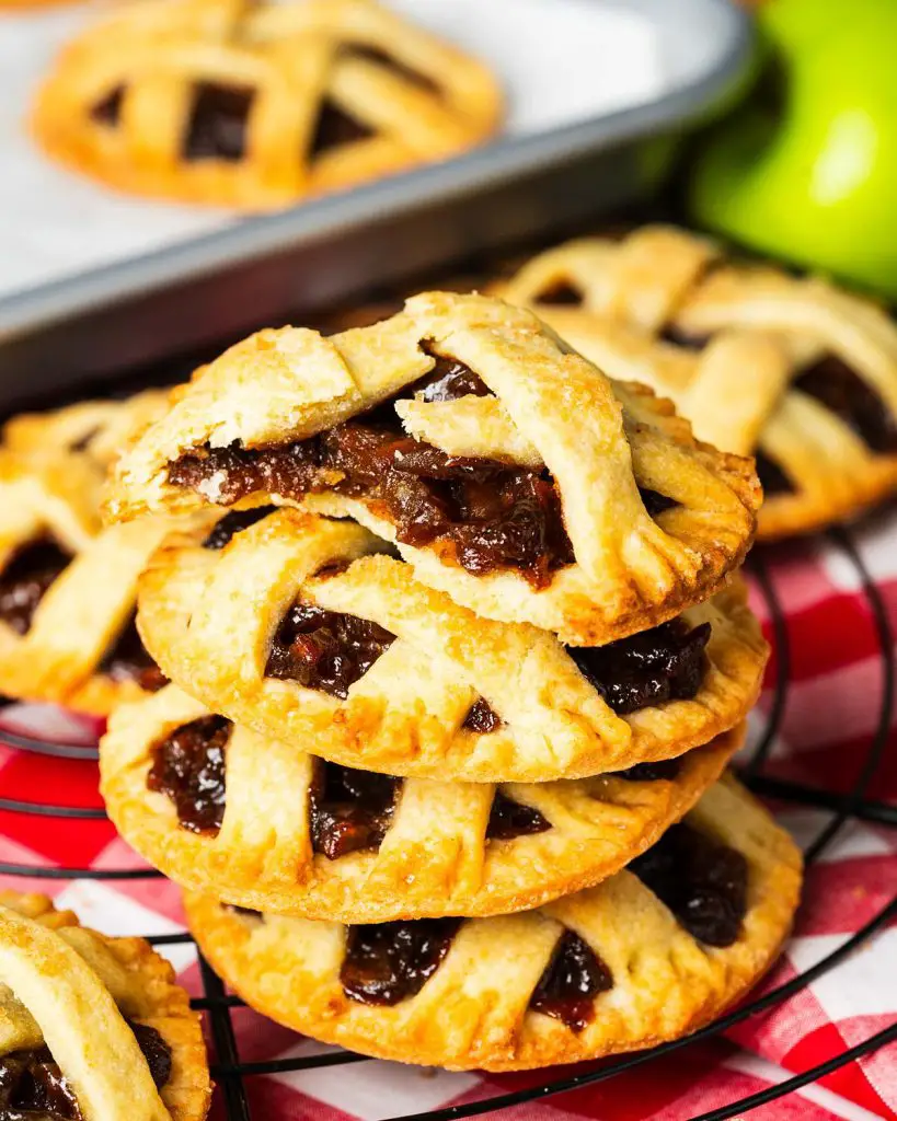 Apple pie cookies have all the joy and delicious cosiness of this homely comfort food, but in a fun cookie instead! Buttery shortcrust pastry, irresistible apple pie filling and a pretty lattice top make these a delight to make and enjoy! Recipe by movers and bakers