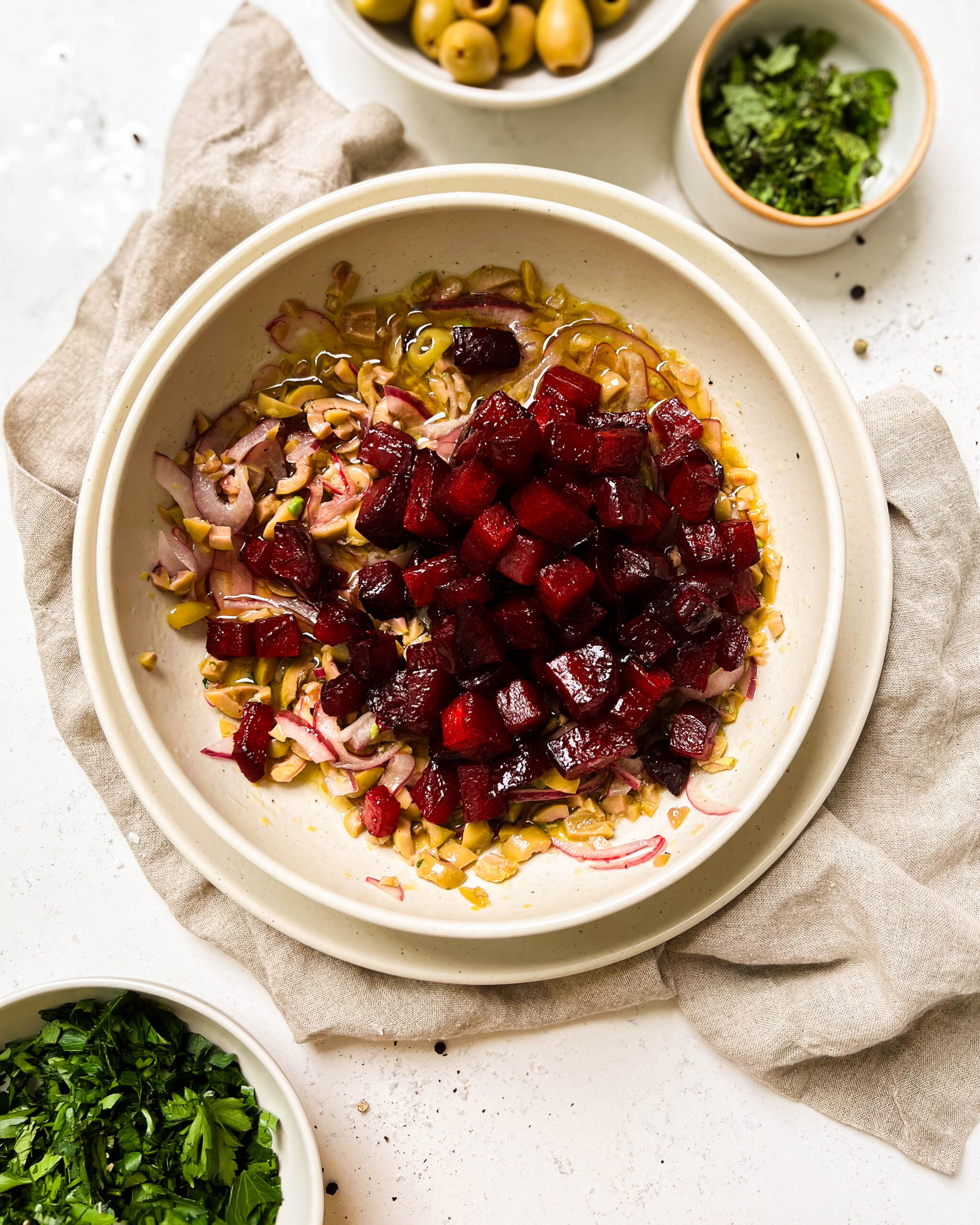 pickled beet salad ingredients in a beige bowl