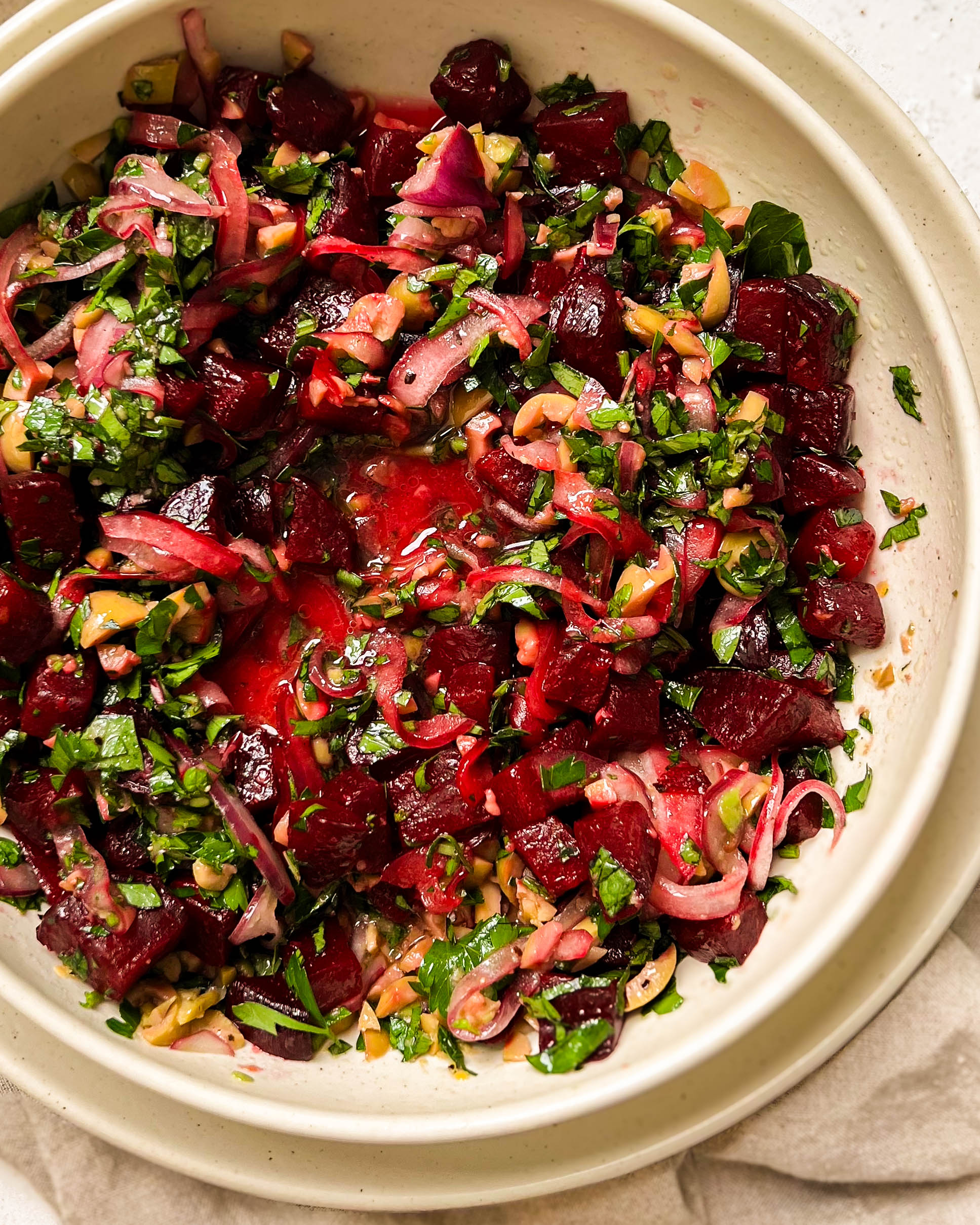 pickled beet salad in a beige bowl