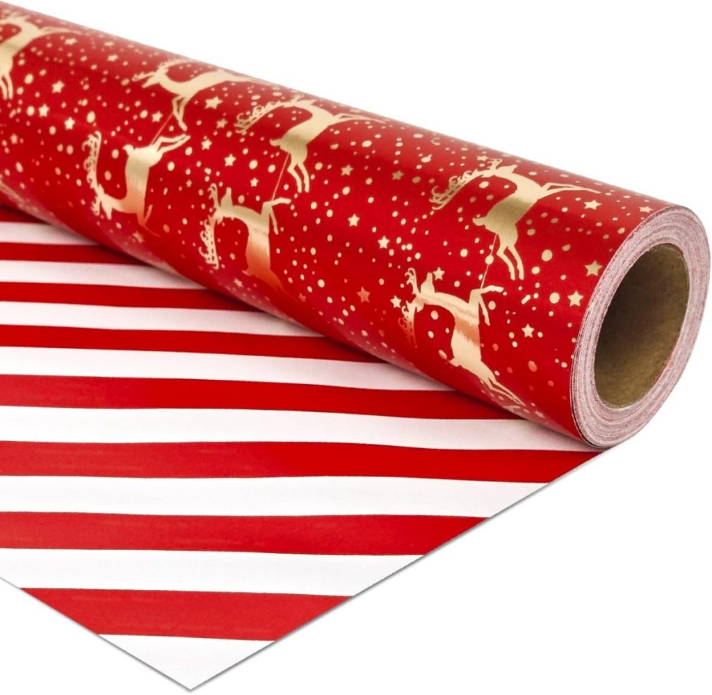 A roll of red wrapping paper with a gold reindeer and stars pattern, perfect for those seeking creative ideas for gift wrapping. Partially unrolled, it reveals festive red and white stripes on the reverse side.