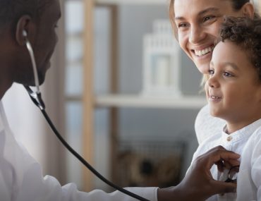 a pediatrician is checking a child