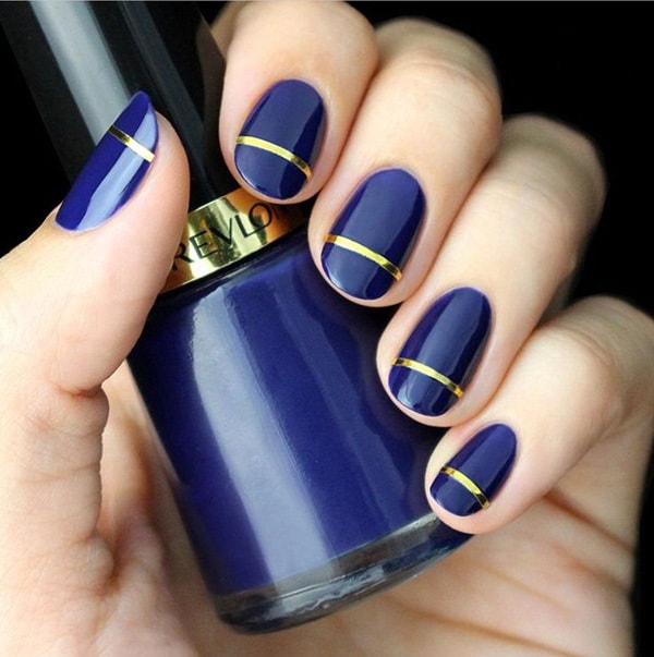 royal blue nail design with one golden line