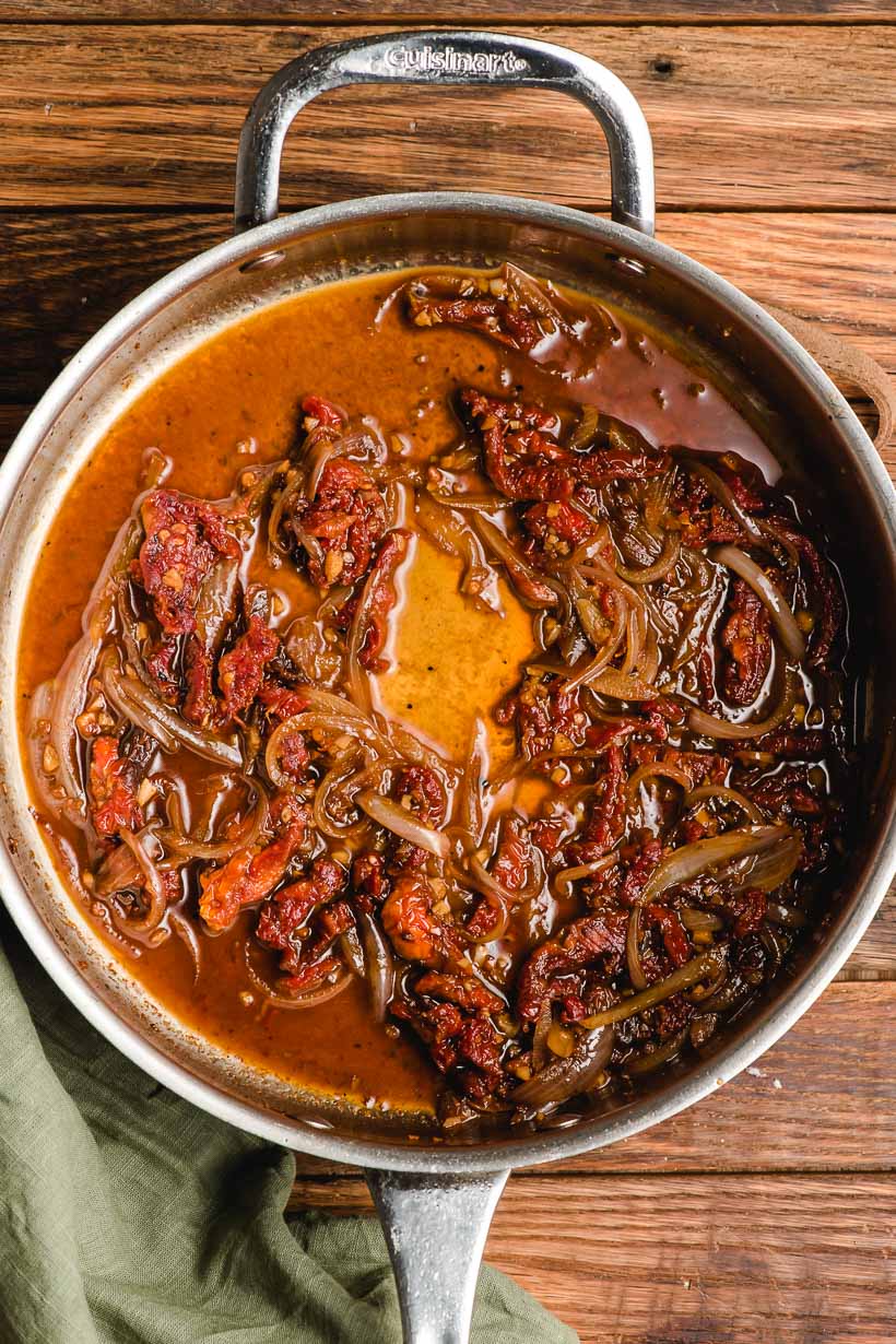 Sun dried tomatoes in a deep stainless steel skillet.