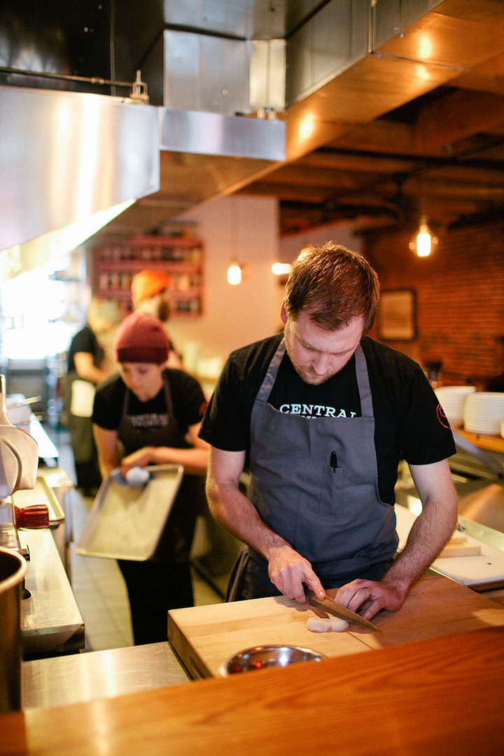 Chef Chris Gould cutting scallops.