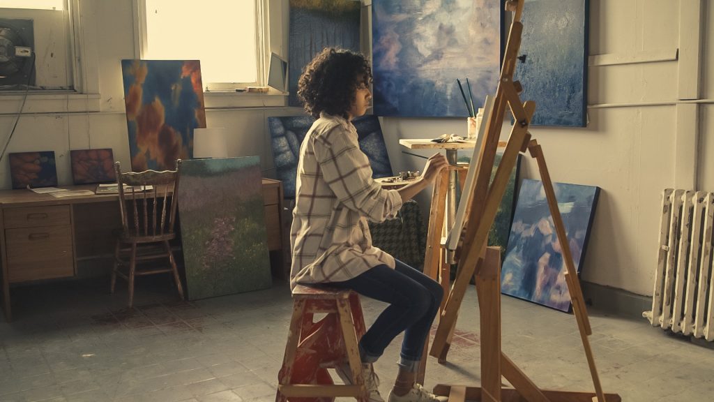 An artist at work in her studio. Photo by Burst from Pexels, public domain.