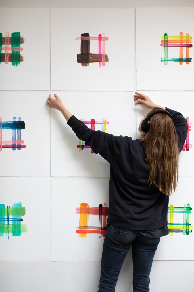 Cj Hendry installing drawings at her exhibition "Plaid." Photo courtesy of the artist.