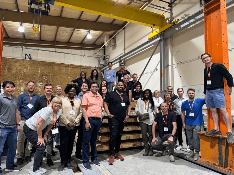 Conference participants group photo in laboratory.