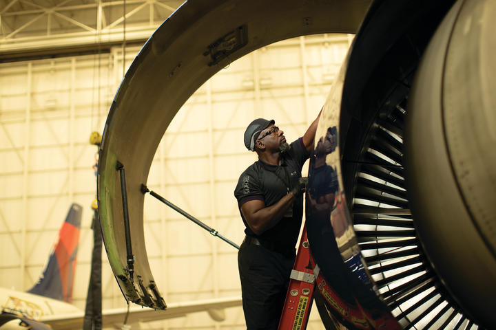 Cedric M. from Delta's TechOps team works on a Delta aircraft.