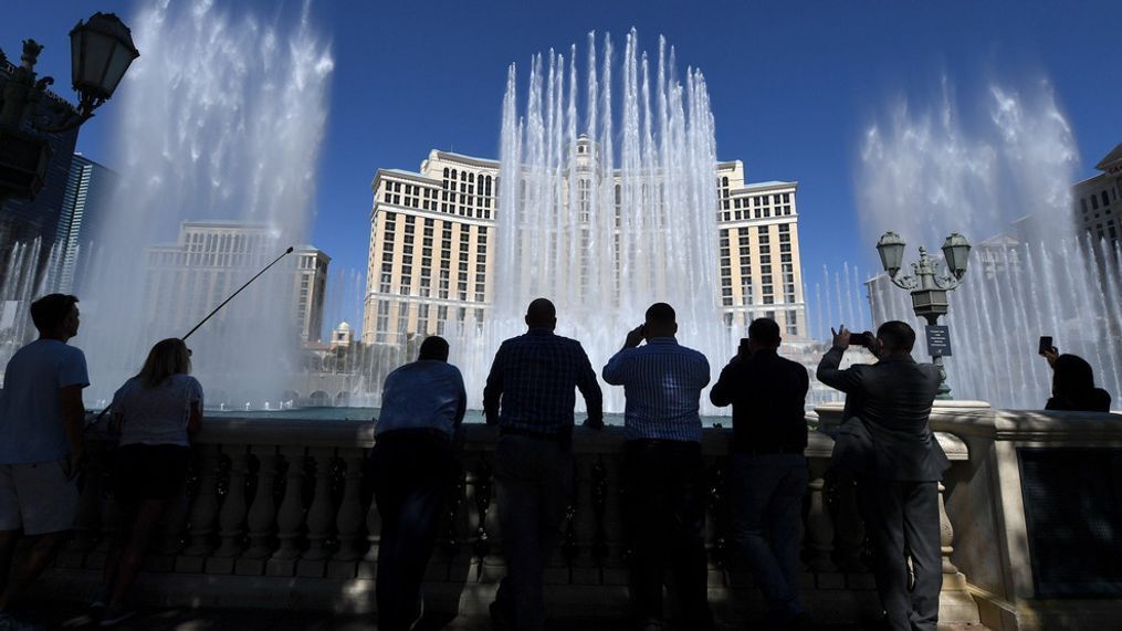 LAS VEGAS, NEVADA - JUNE 04:  Visitors and MGM Resorts International employees watch The Fountains of Bellagio launch for the first time since the resort closed on March 17 because of the coronavirus (COVID-19) pandemic on June 4, 2020 in Las Vegas, Nevada. The fountains went off twice twice just before the doors were opened; first to the song "Simple Gifts," a tribute to frontline workers around the world, and then to "Viva Las Vegas," to celebrate Las Vegas residents. Hotel-casinos throughout the state are opening today as part of a phased reopening of the economy with social distancing guidelines and other restrictions in place. MGM Resorts International reopened Bellagio, New York-New York Hotel & Casino, MGM Grand Hotel & Casino and The Signature today.  (Photo by Ethan Miller/Getty Images)