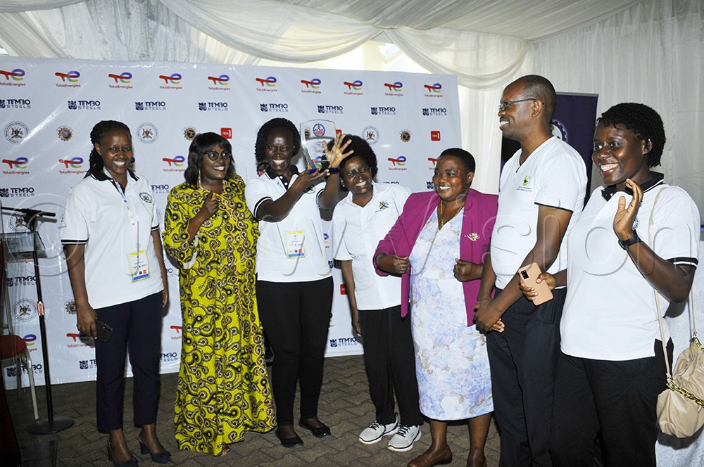 Prime Minister Robinah Nabbanja  with scientists  behind the  baby incubator machine 