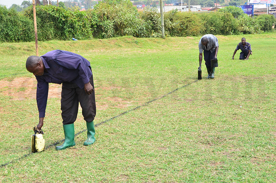 Men marking the football pitch 