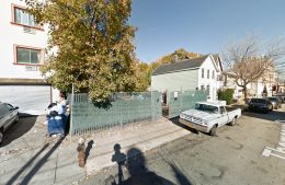 61-67 Thompson Street extending from the edge of the fence to the two-story white building, via Google Maps