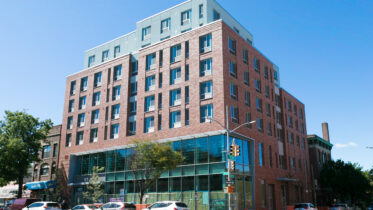 Exterior of the Sunset Park Library and Apartments, via Fifth Avenue Committee