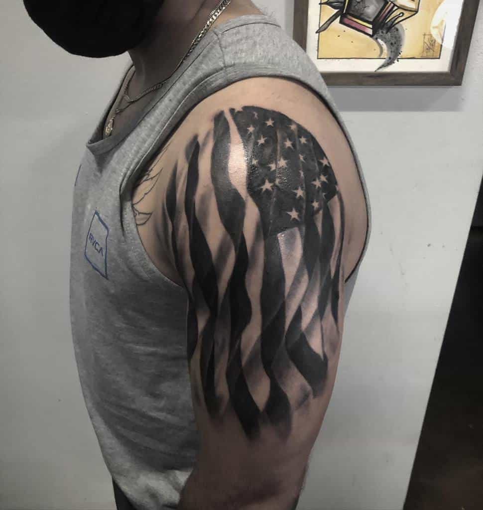 Man with a tattoo of a stylized U.S. flag on his upper arm