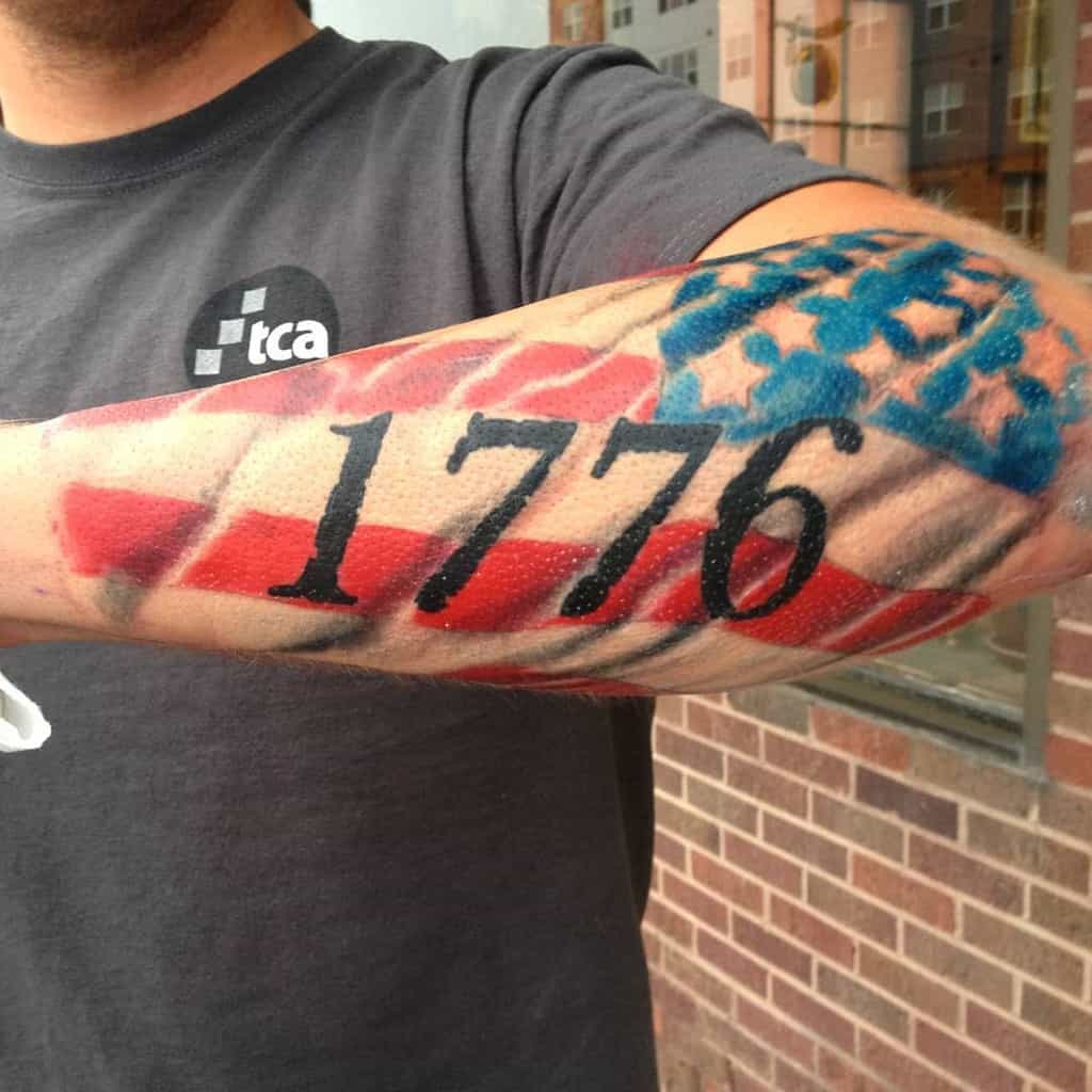 Arm tattoo with "1776" and American flag design