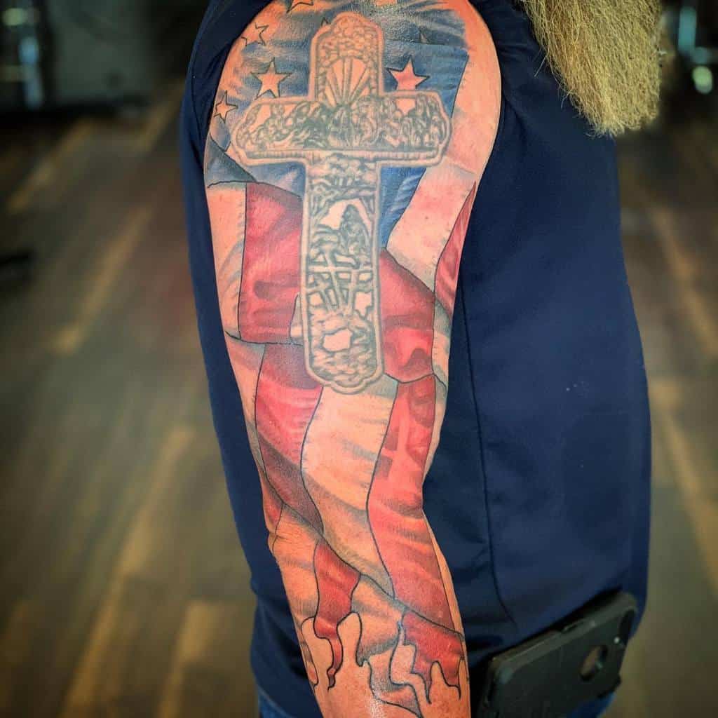 Arm tattoo with a cross and American flag design